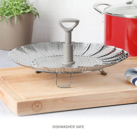Folded legs extended to fit a variety of pans