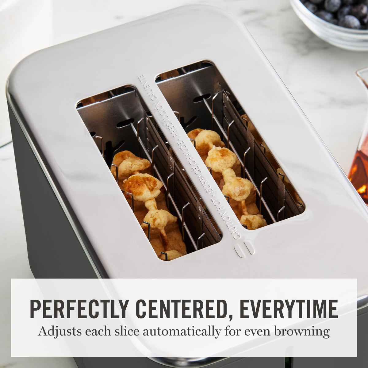 Wide slot design demonstrates capacity for bagels, waffles, and artisan bread.