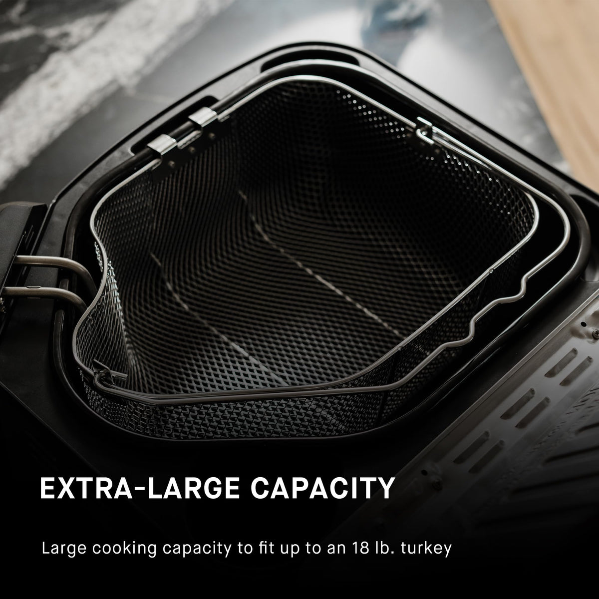 Masterbuilt cooking basket with lifting hook for safe handling.