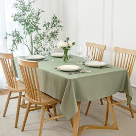Maxmill rectangle-slubby-textured tablecloth in sage green enhances an elegant dining setting.