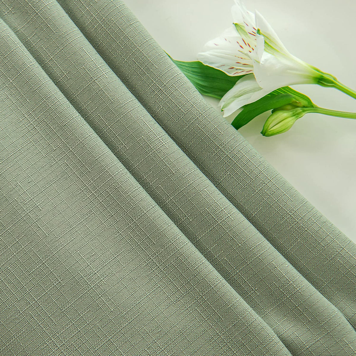 Maxmill versatile occasions are supported by this sage-green tablecloth.