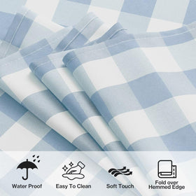 Maymiss outdoor picnic scene with tablecloth protecting tables at a sunny gathering.