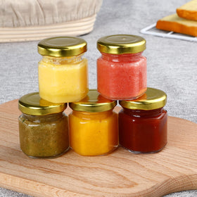 McUpper wedding favors kit: glass jars with gold lids.