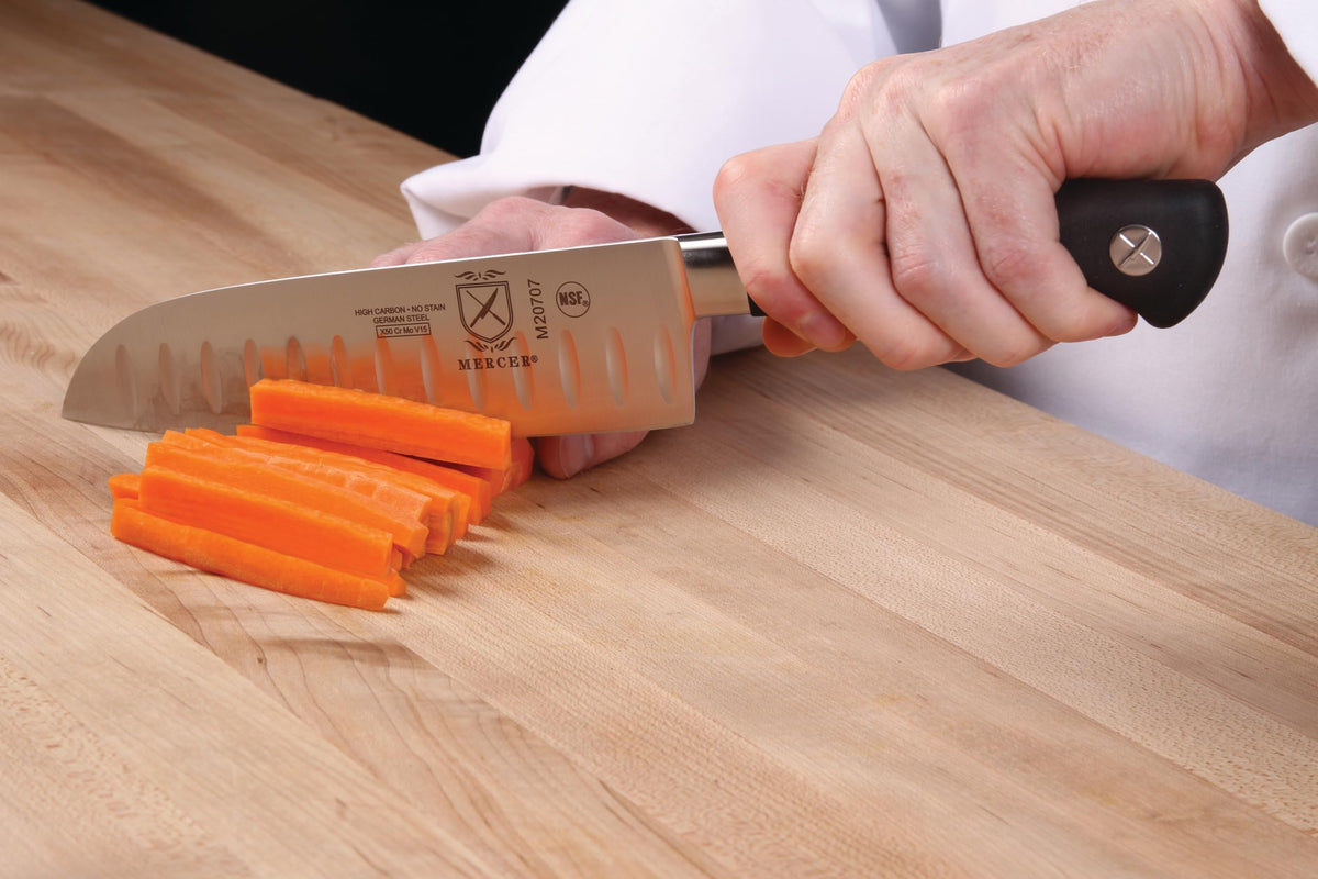 Mercer Genesis 7in Santoku on cutting board ready for chopping and mincing.