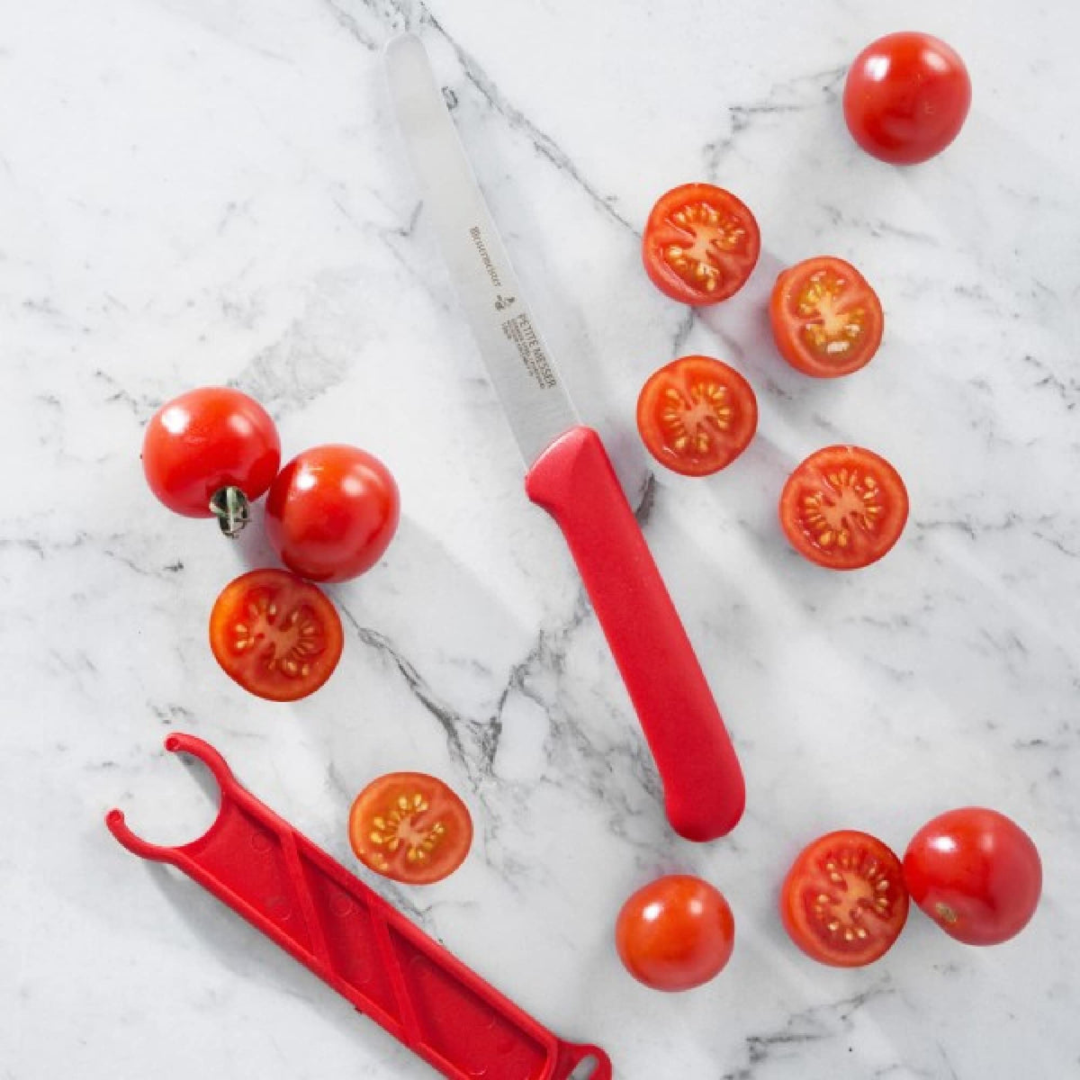 Messermeister tomato knife with sheath stored neatly in kitchen drawer.