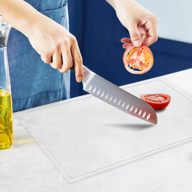 MEWSDEN acrylic cutting board with juice groove catching liquids on the counter