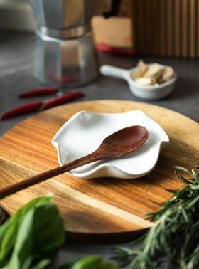 Miamolo spoon rest on countertop doubles as a decorative spill protector.