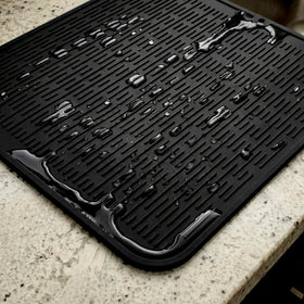 MicoYang silicone drying mat beside dishes for quick air drying.