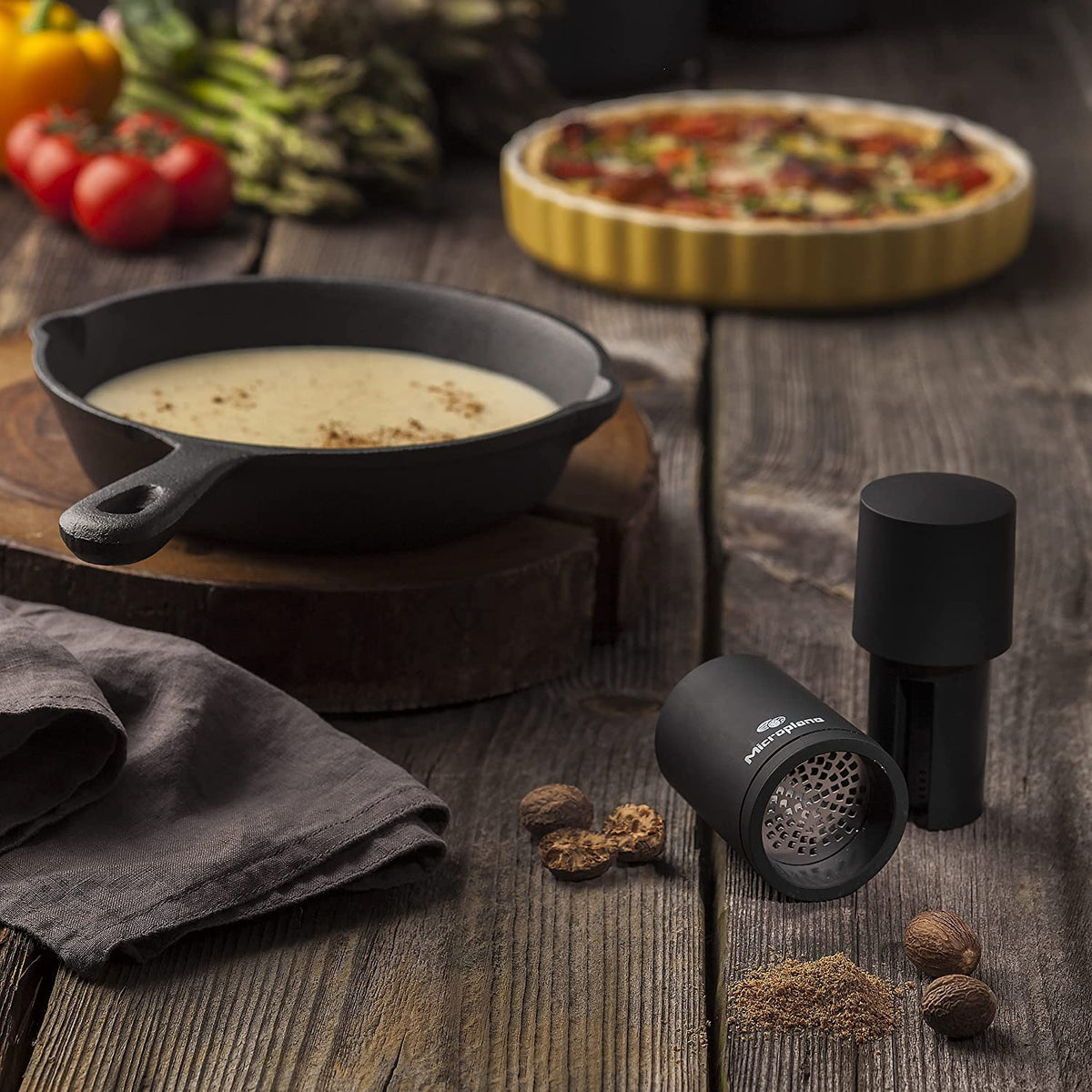 Microplane spice mill black surface on countertop adds modern elegance.