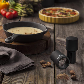 Microplane spice mill black surface on countertop adds modern elegance.