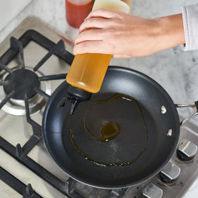 Bottles show measurement markings for precise dosing in recipes.