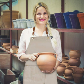 Mignongirl crossback apron used in kitchen or studio for versatile work.