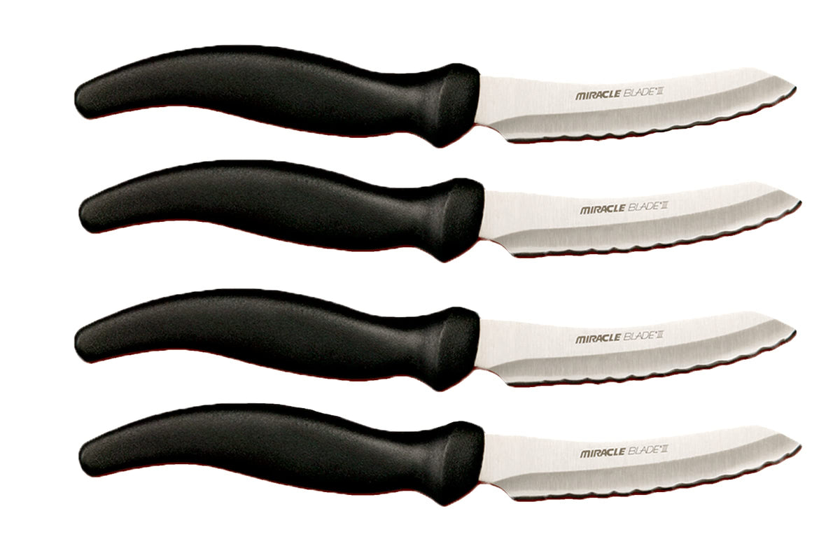 Miracle Blade III steak knife set on dining table, four-piece precision for meals.