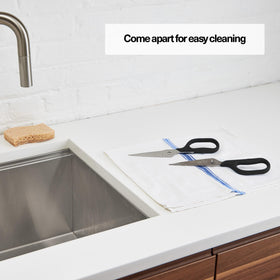 Misen Heavy Duty Kitchen Shears snipping fresh herbs efficiently for culinary prep.
