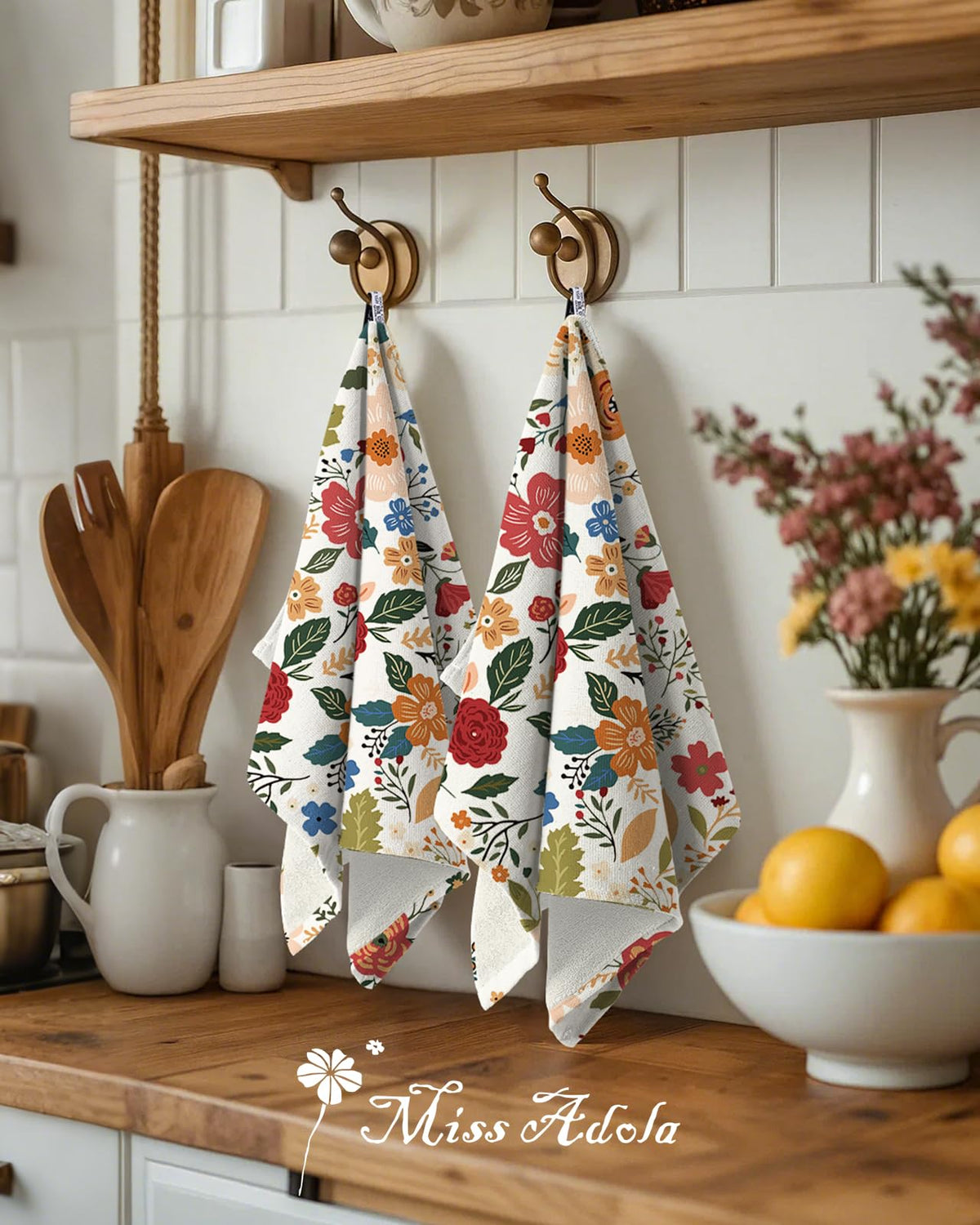 Miss Adola decorative floral design towels add charm to kitchen decor.