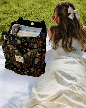 Miss Adola tote showing magnetic closure buckles for quick access