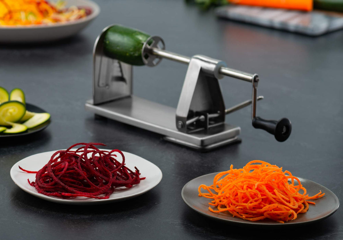 MITBAK spiralizer with suction base in action for stable counter use.