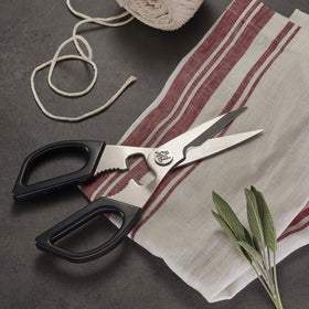 Miyabi kitchen shears bone breaker and bottle opener demonstrated for versatile kitchen tasks.