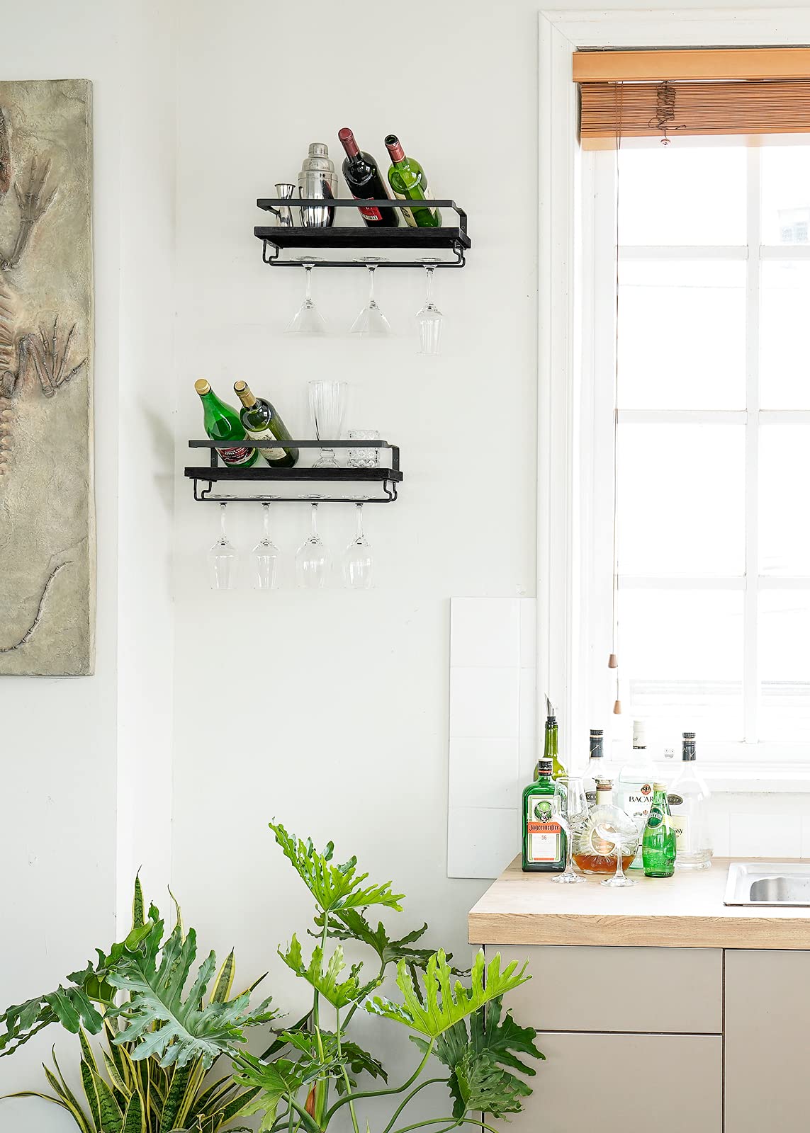 Mkono floating shelves displaying bottles glasses and photos in a modern kitchen.