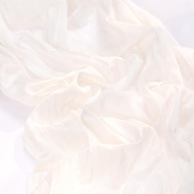 MLMC ivory cheesecloth runner used as a backdrop for a photoshoot table