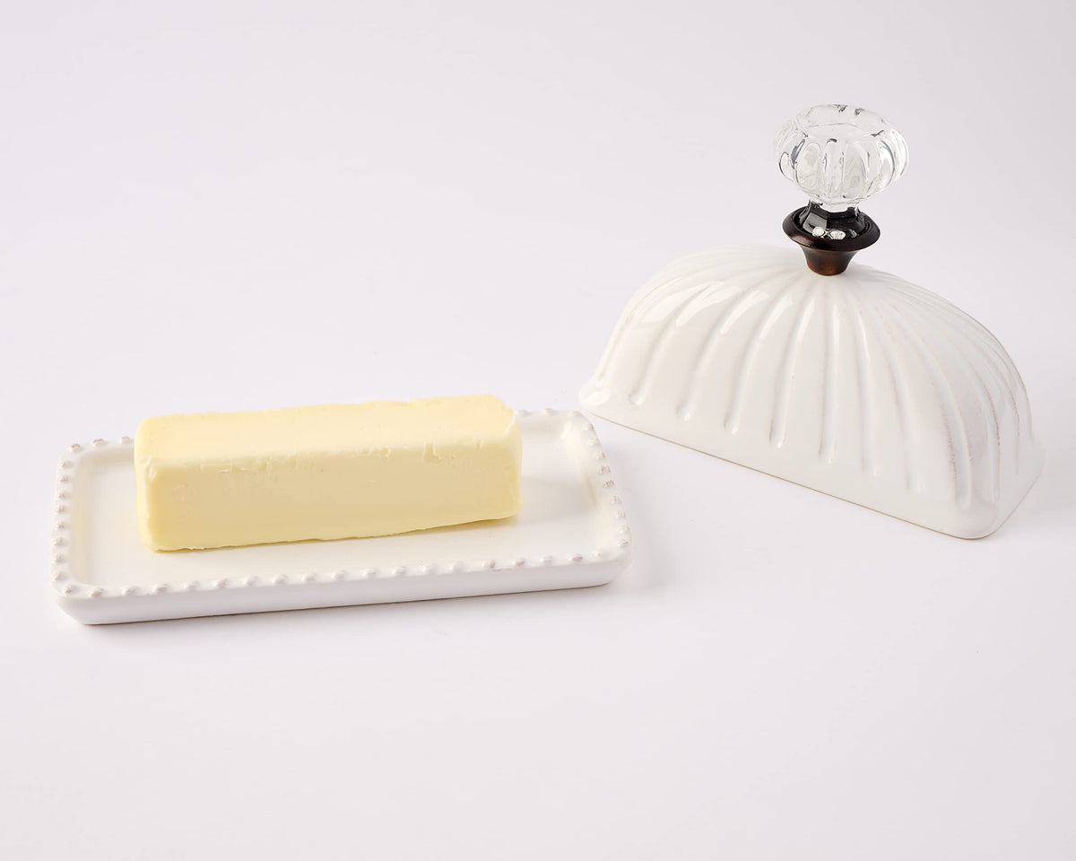 Mud Pie lid and dish on a table under warm light for inviting presentation.