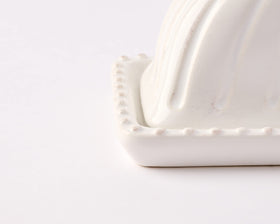 Mud Pie white ceramic butter dish on the counter offers timeless kitchen style.
