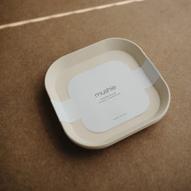 Mushie ivory two-pack on table ready for family meal
