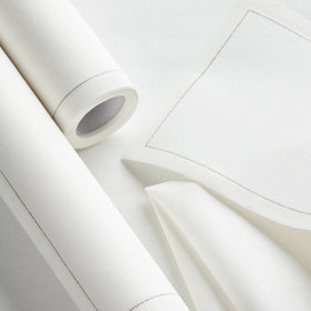 Perforated roll of MY DRAP Basics napkins with easy tear edge in cream.