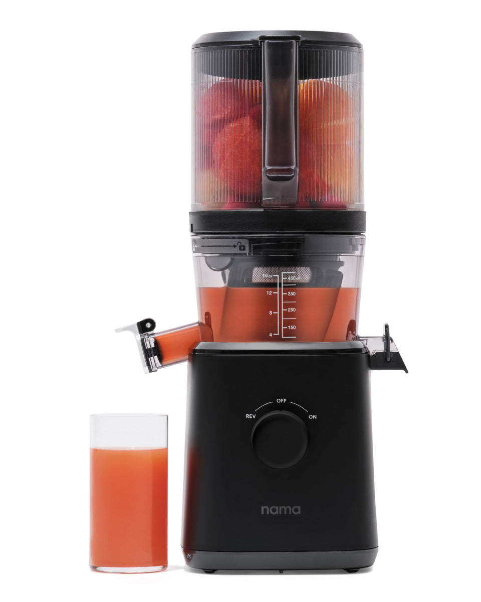 Nama J2 Juicer with self-feeding hopper enabling hands-free loading for multitasking.