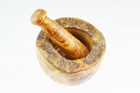 Naturally Med olive wood mortar and pestle in-use for grinding herbs