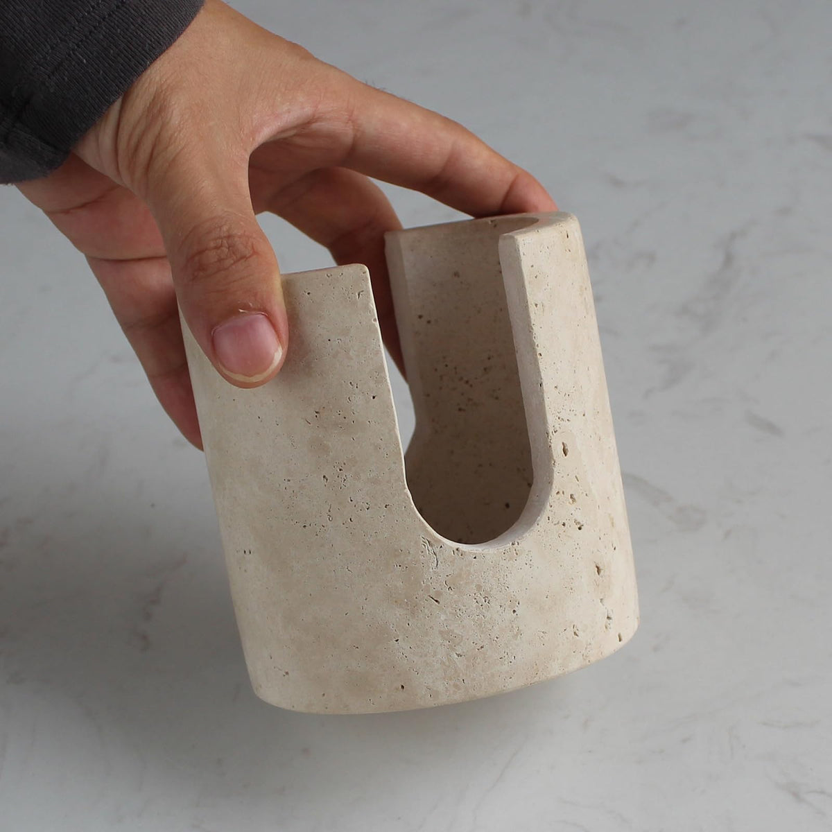 Nawgnail sink organizer in beige travertine absorbs moisture for a cleaner counter.