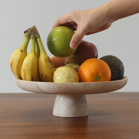 Nawgnail travertine fruit bowl daylight scene as everyday dining centerpiece.