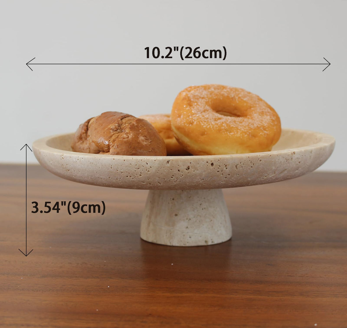Nawgnail travertine fruit bowl side angle highlights pedestal design.