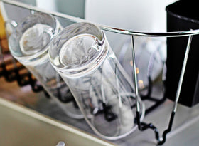 Neat-O Deluxe chrome dish drainer with detachable cutlery cup for utensils.