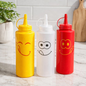 New Star Foodservice condiment squeeze bottle with smiley design in clear, shows exact contents