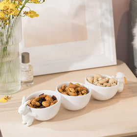 Newman House Studio hand-painted gold accents on bunnies enhance chic display.
