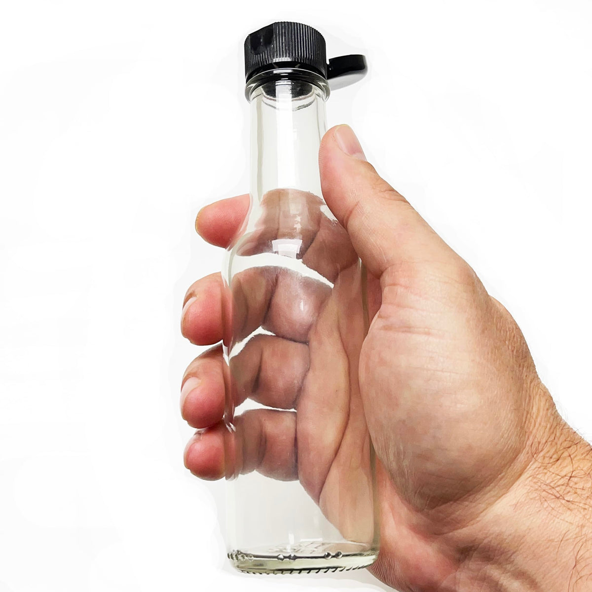 Nicebottles clear glass bottles display vibrant sauces during bottling.