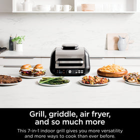 Ninja IG651 12-inch BBQ griddle cooking a variety of foods evenly.