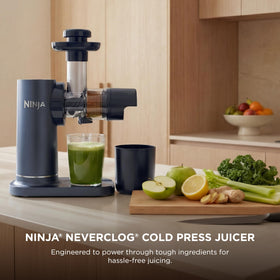 Close up of the Ninja NeverClog auger powering through celery and kale