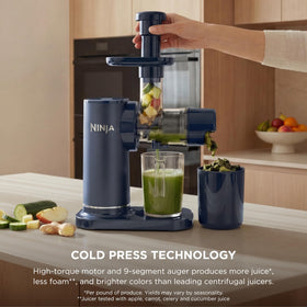 Pouring smooth juice from Ninja NeverClog 24 oz jug