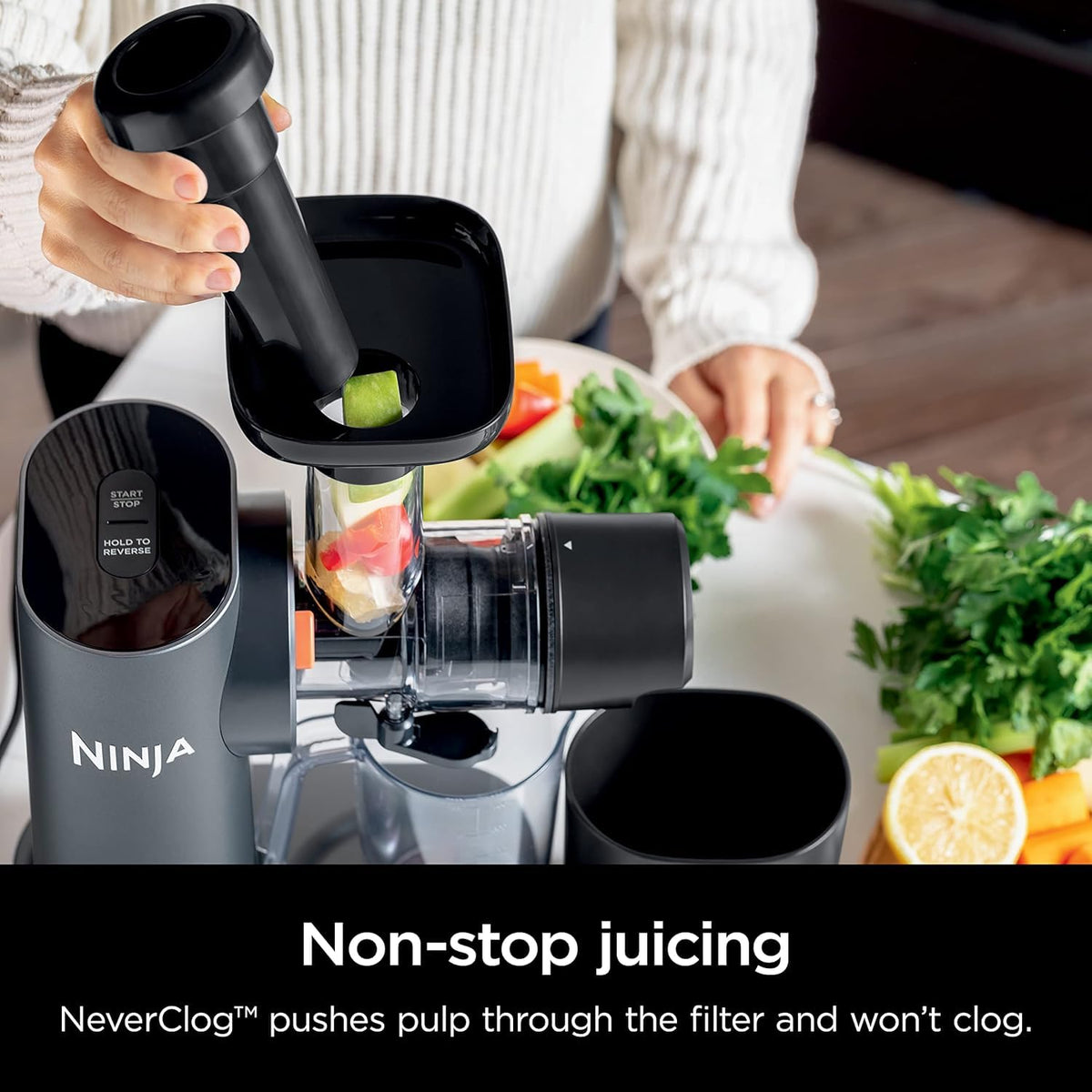 Ninja NeverClog juicer juice jug; convenient 24 oz capacity for fresh servings.