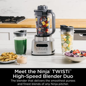 Ninja TWISTi blender tamper demonstrating built-in push-down blending action.