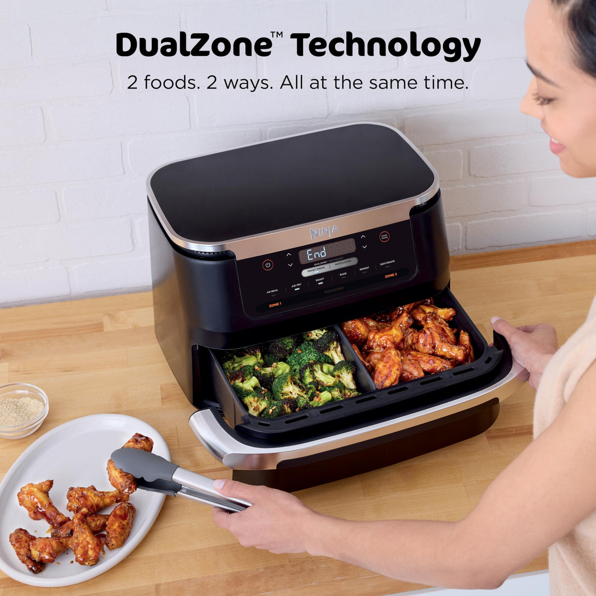 Ninja Foodi two-basket setup with divider enables synchronized cooking.