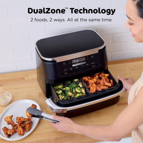 Ninja Foodi two-basket setup with divider enables synchronized cooking.