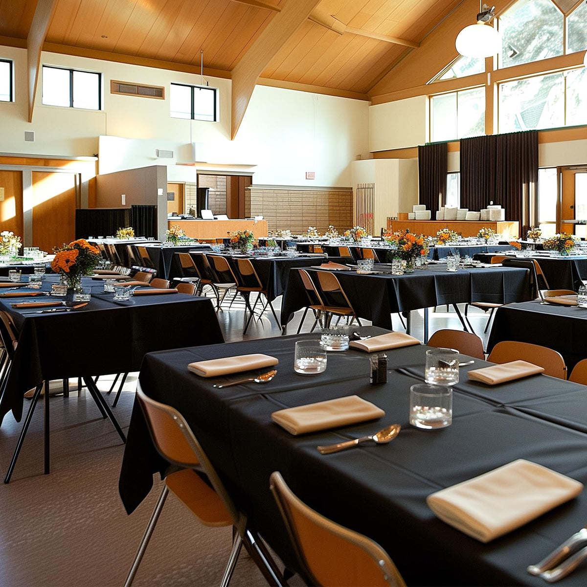 Niuara black disposable tablecloth on a 6ft rectangle table offers tear-resistant, spill-proof protection.