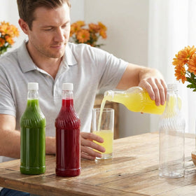 Noamus empty clear juice bottle ready for DIY beverage customization.