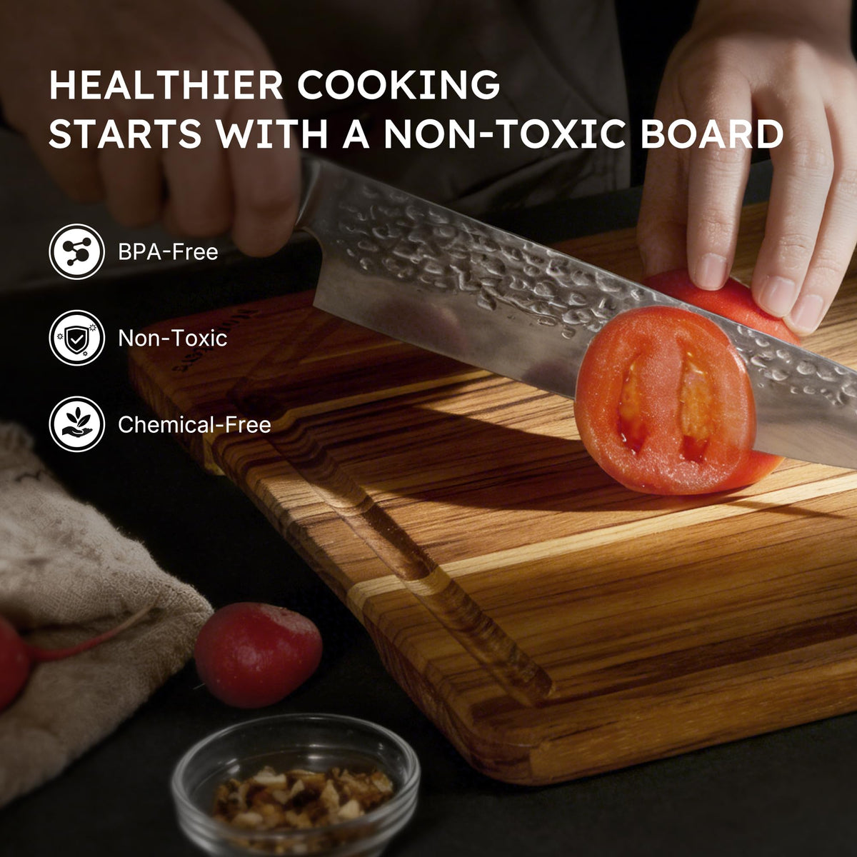 Nomsters teak board in use for meat prep on a sturdy surface