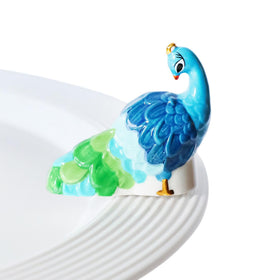 Nora Fleming Fancy Feathers Peacock mini on display adds vibrant color to any space.