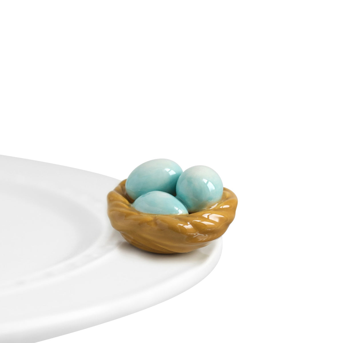 Nora Fleming Robin Egg Blue Nest hand-painted mini on display adds spring charm