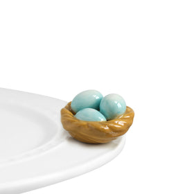Nora Fleming Robin Egg Blue Nest hand-painted mini on display adds spring charm
